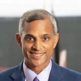 Steve Rao in a suit smiling