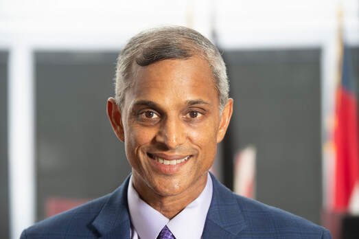 Steve Rao in a suit smiling